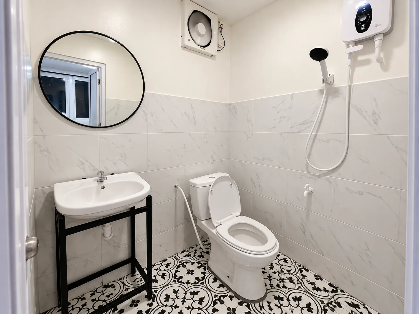 The private bathroom with patterned black-and-white floor tiles